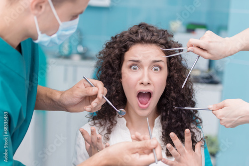 фотографія Scared young woman at dentist appointment