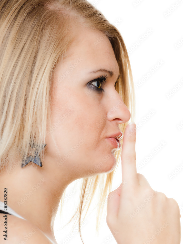 Blonde girl with finger on lips asking for silence Blonde girl with finger on lips asking for silence
