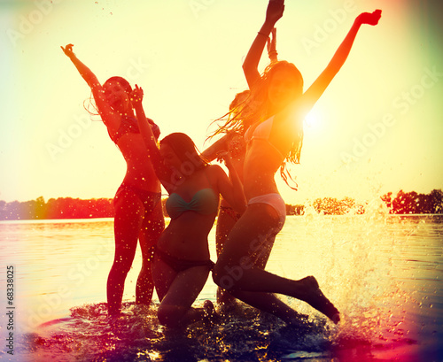 Beach party. Teenage girls having fun in water