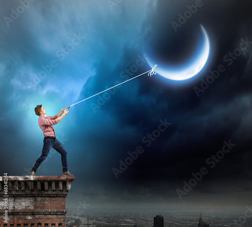 Man catching moon