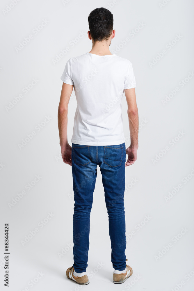 Serious young man standing against white background Serious young man standing against white background