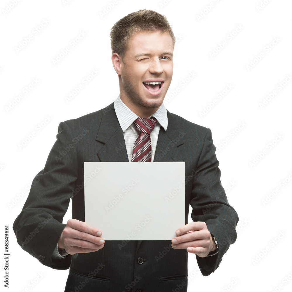 young winking businessman holding sign young winking businessman holding sign