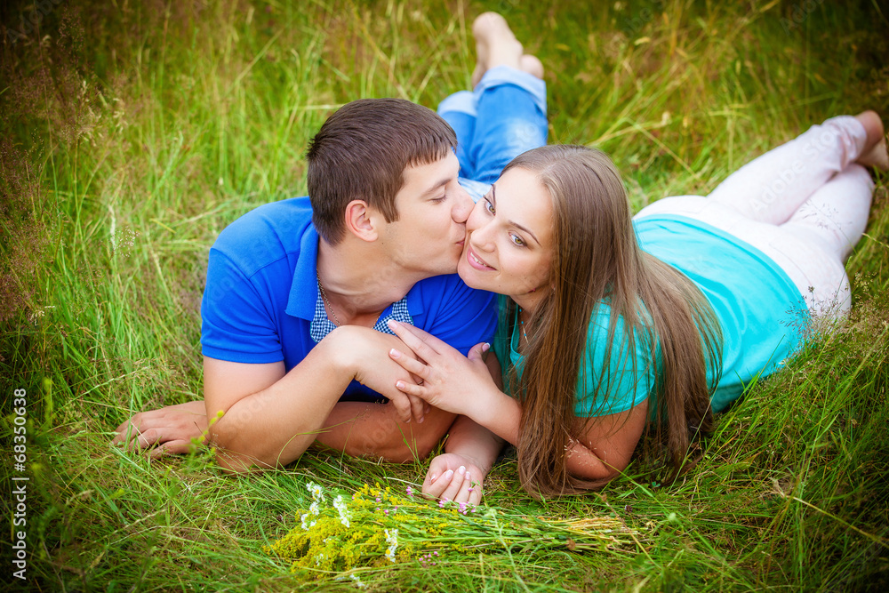 Romantic couple relaxing in field Romantic couple relaxing in field