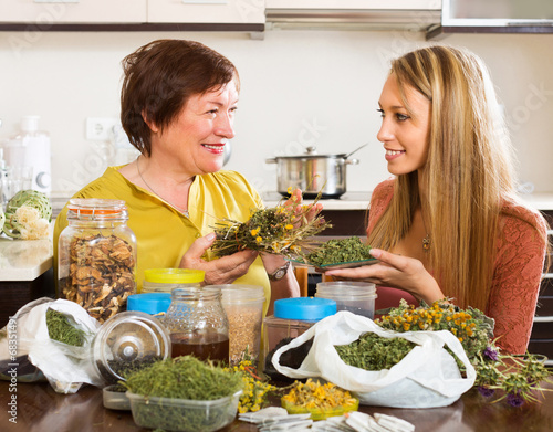 Two women with dried herbs