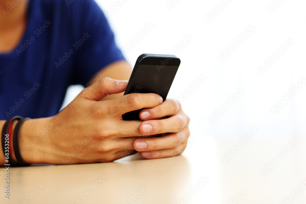 Closeup portrait of a male hands holding smartphone