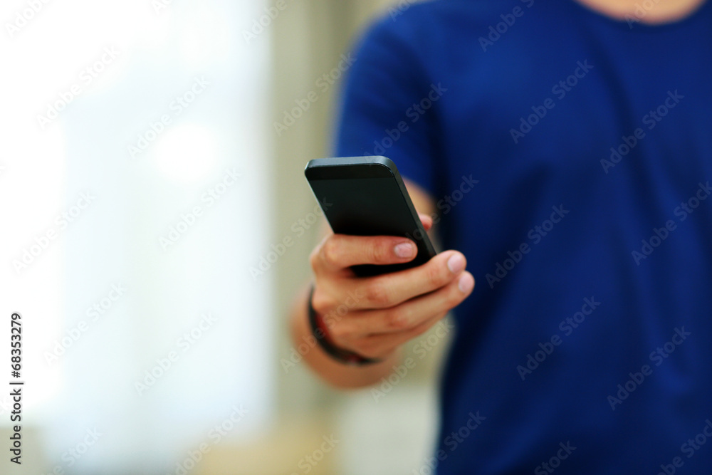 Closeup portrait of a male hands holding smartphone