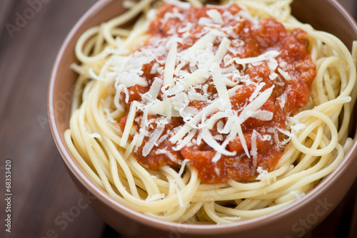 Close-up of spaghetti with bolognese sauce and parmesan cheese