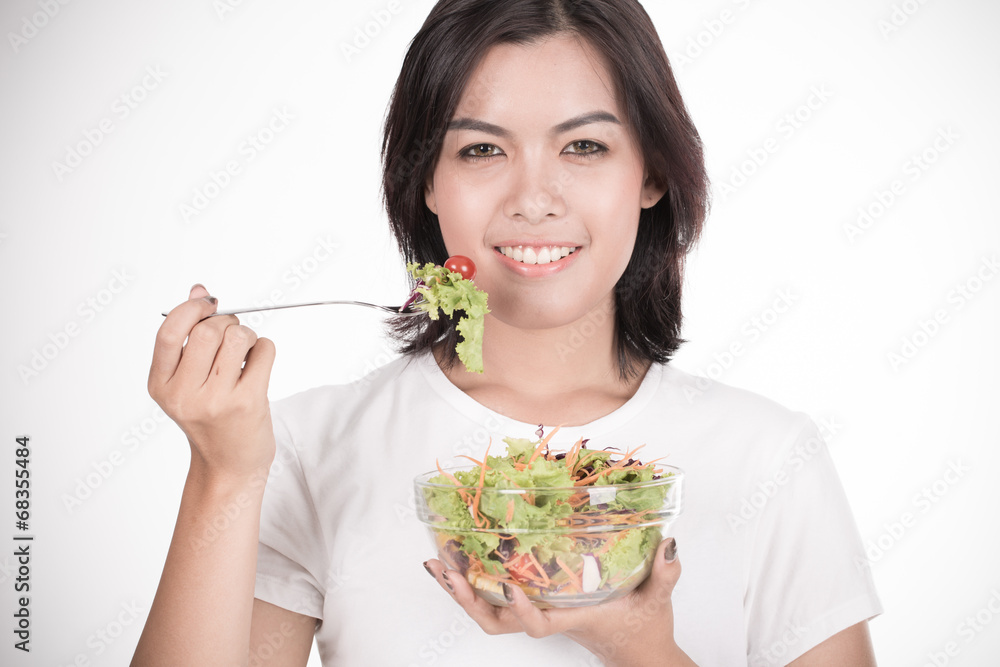 Pretty girl eating fresh vegetable salad Pretty girl eating fresh vegetable salad