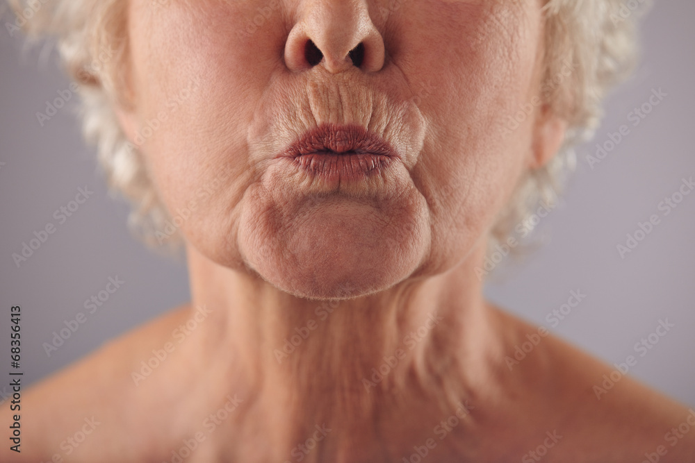 Fototapeta premium Mature woman puckering lips