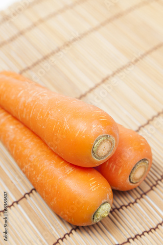 Carrots on wooden plate