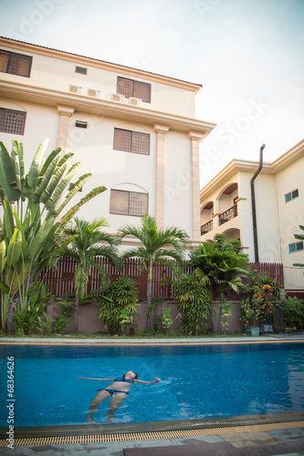 Girl relaxing in the swimming pool photo