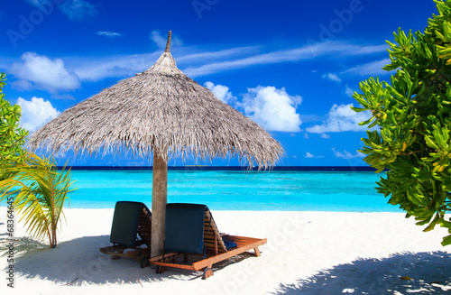 Beach chairs on tropical beach #68364645