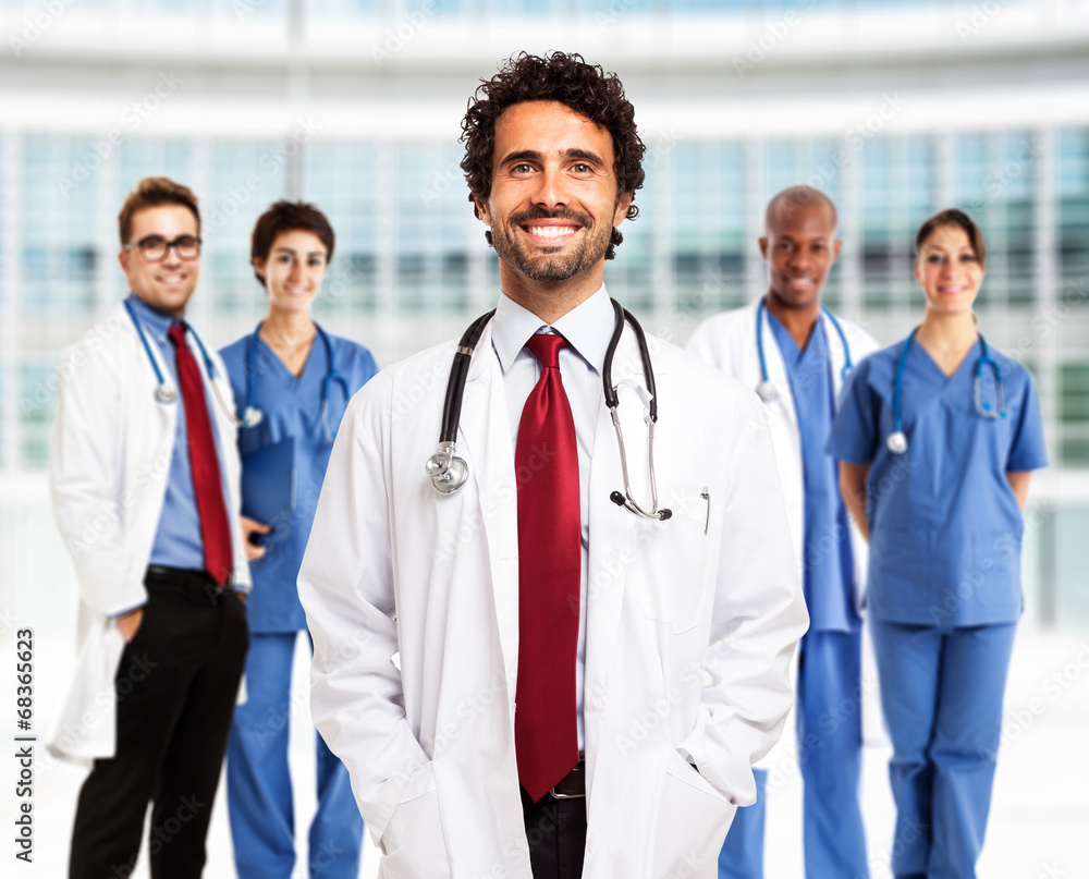 Smiling doctor in front of his team Smiling doctor in front of his team