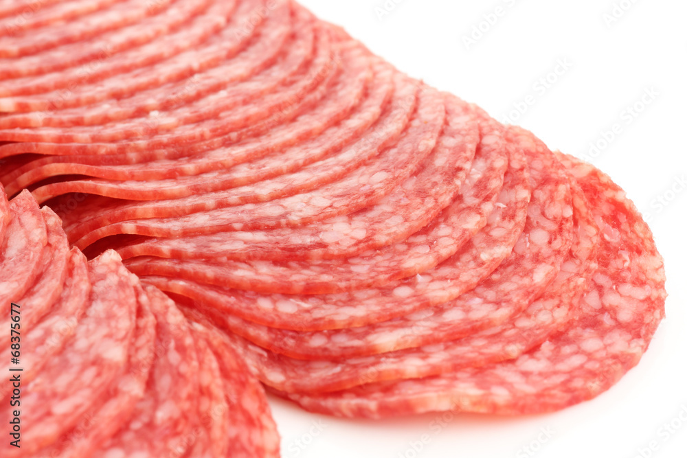 Freshly sliced salami rounds on white. Freshly sliced salami rounds on white.
