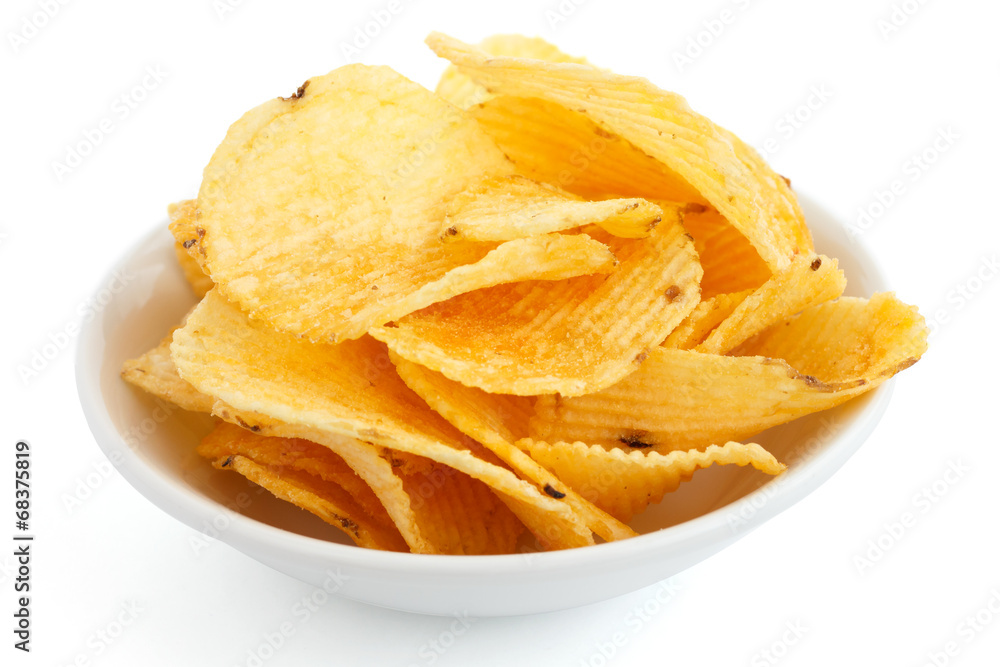 Crinkle cut crisps in a white bowl on white background. Crinkle cut crisps in a white bowl on white background.