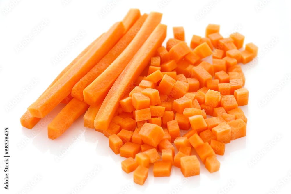Diced and sliced carrots on white surface Diced and sliced carrots on white surface