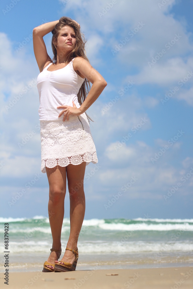 Young woman with long hair posing sexy near the beach Young woman with long hair posing sexy near the beach