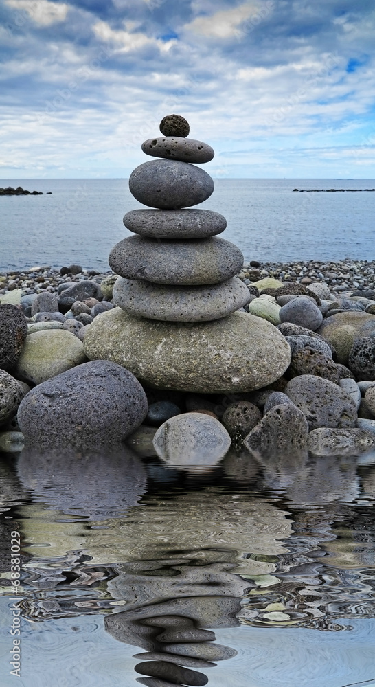 Fototapeta premium stack of stones on the beach and sea background.