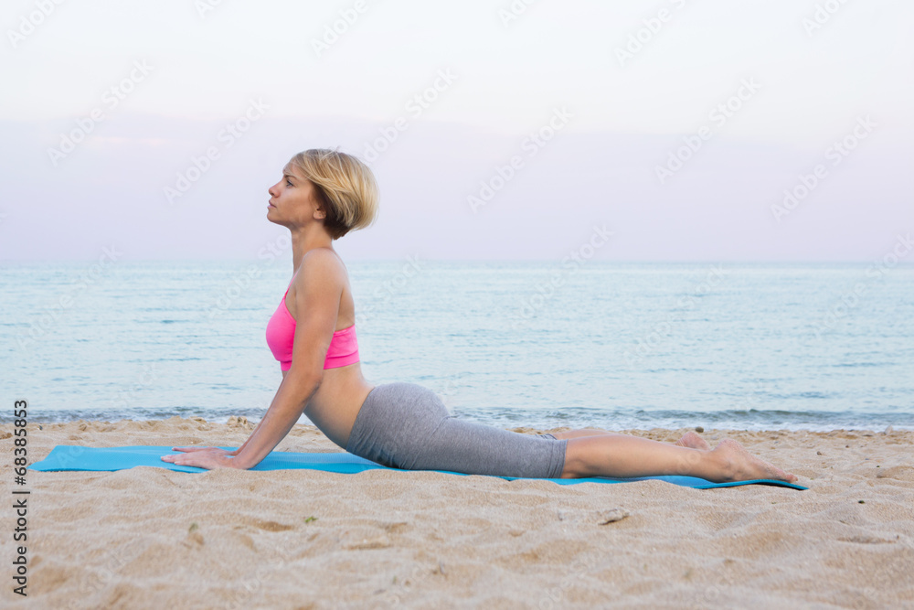 Cobra pose stretching on the beach Cobra pose stretching on the beach