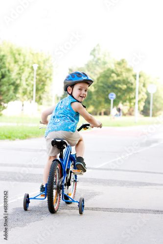 Baby boy on bike with crash helmet