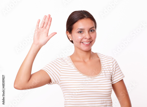 Cute hispanic girl with greeting gesture
