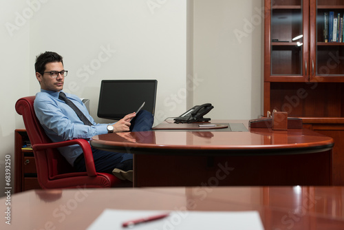 Young Man Working On Computer In Office