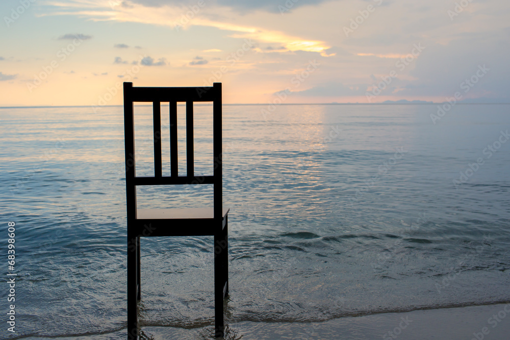 Chair on the beach with sunset.