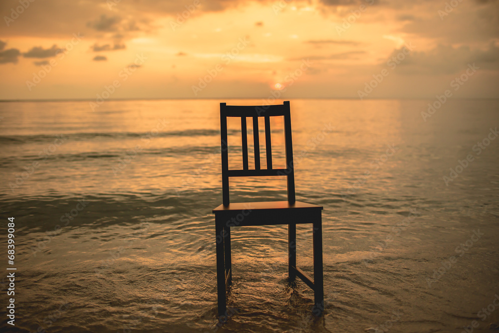Chair on the beach with sunset.
