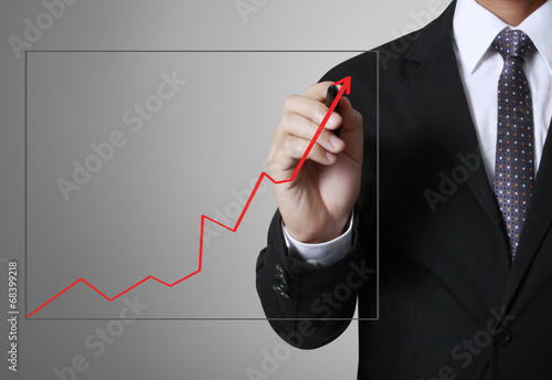 business man writing over target graph