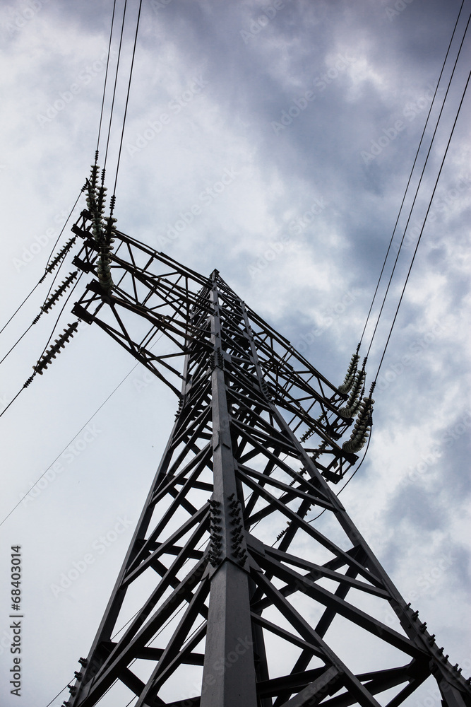 Electricity pylon against the cloudy sky background Electricity pylon against the cloudy sky background