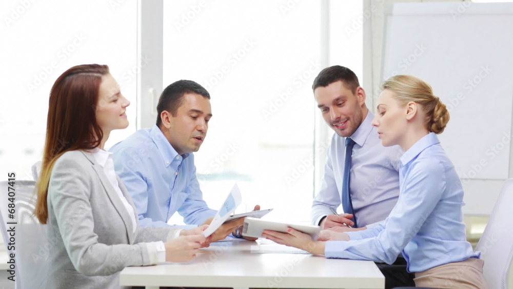 smiling team with table pc and papers working smiling team with table pc and papers working