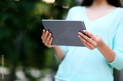 Closeup portrait of a woman holding tablet computer