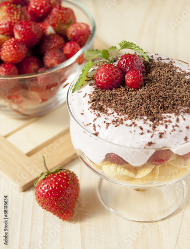 Dessert with curd cream, cereal, strawberries and chocolate.