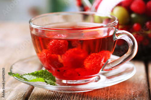 Fruit red tea with wild berries in glass cup,