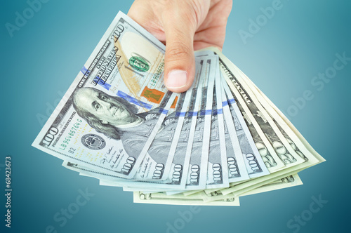 Hand holding money - United States dollar (USD) bills
