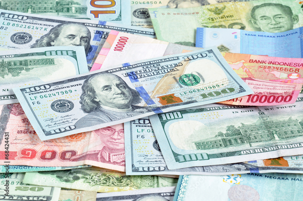 Money in multi currencies with 100 USD bill on top Money in multi currencies with 100 USD bill on top