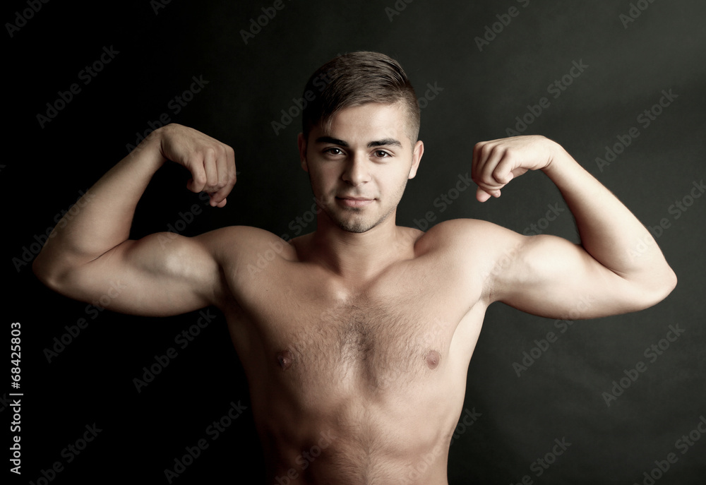 Portrait of muscle man on dark background Portrait of muscle man on dark background