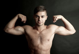 Portrait of muscle man on dark background