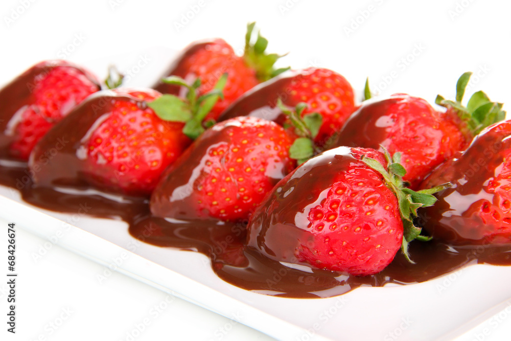 Strawberry dipped in chocolate fondue isolated on white Strawberry dipped in chocolate fondue isolated on white