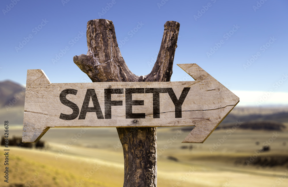 Safety wooden sign with a desert background