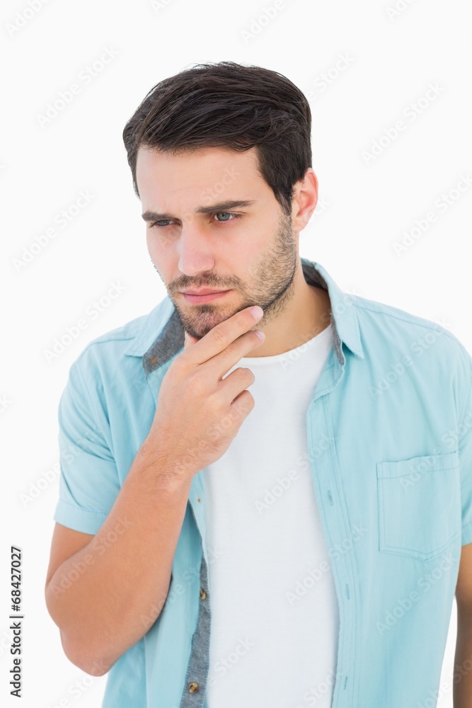 Happy casual man thinking with hand on chin Happy casual man thinking with hand on chin
