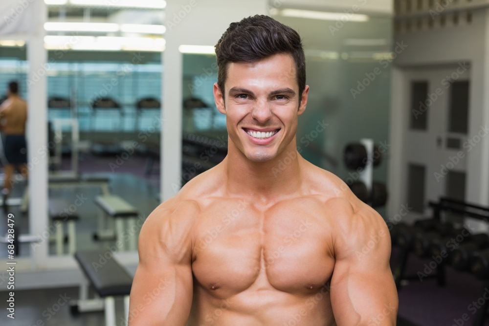Smiling shirtless muscular man in gym Smiling shirtless muscular man in gym