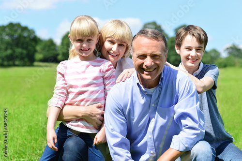 Joyful family of four on a bright sunny day