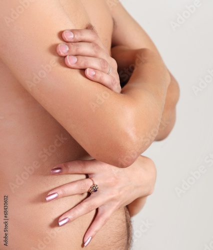 Muscular naked man and female hands