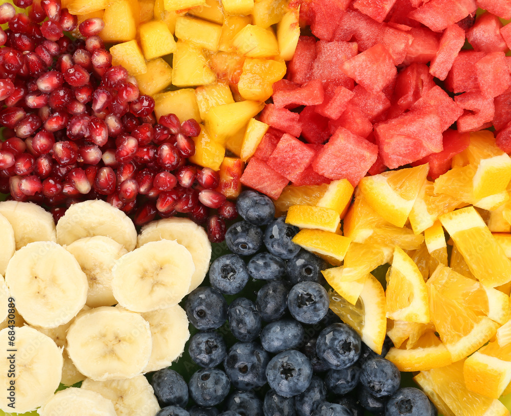 Sliced fruits on plate on wooden table Sliced fruits on plate on wooden table