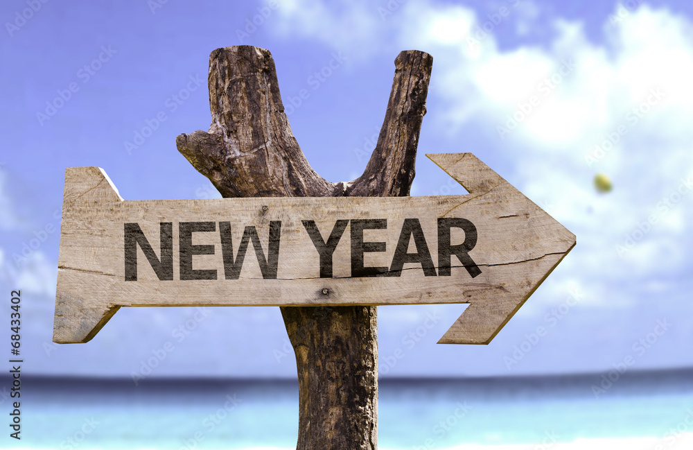 New Year wooden sign with a beach on background