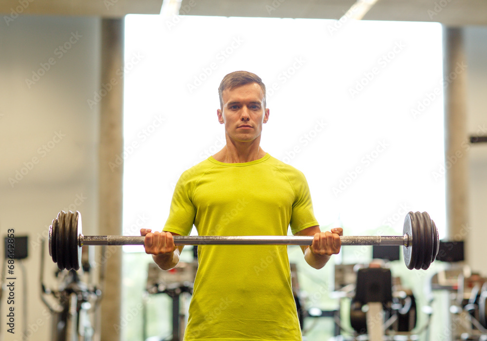 man doing exercise with barbell in gym man doing exercise with barbell in gym