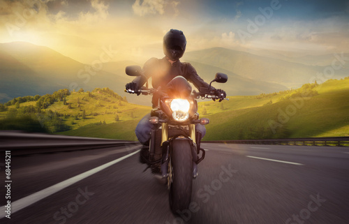 Man seat on the motorcycle on the mountain road