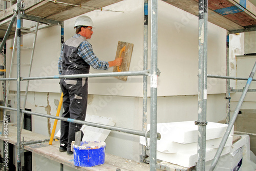 Photos Wärmedämmung, Hausisolierung, Handwerker mit Glättbrett