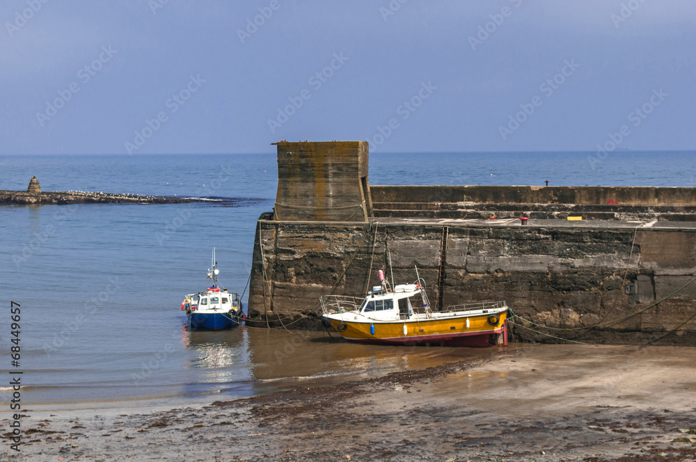 Fototapeta premium Fishing Boats Moored by Harbour Wall